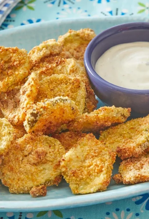 pioneer woman air fryer pickles served golden and crispy on a plate with ranch dressing