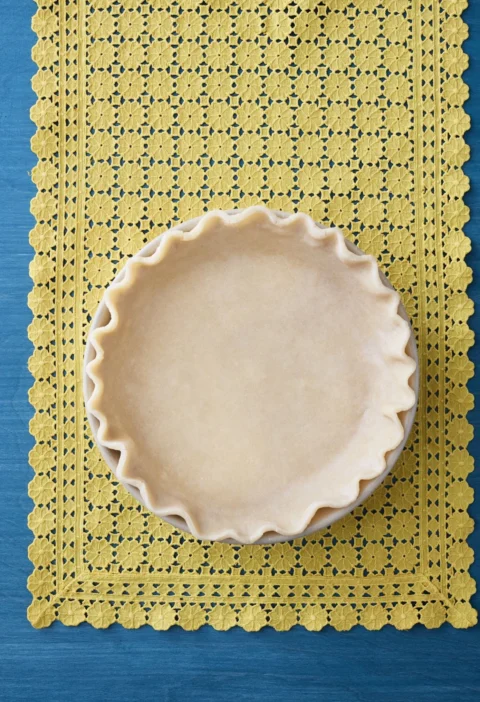 pioneer woman all shortening pie crust rolled out and fitted into a pie plate with crimped edges