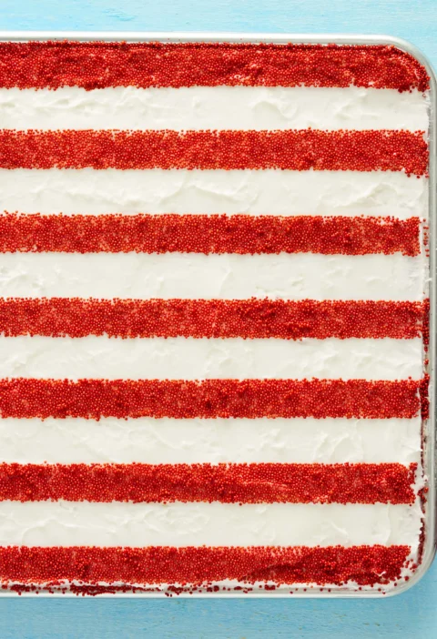 pioneer woman american flag cake decorated with red white and blue sprinkles on a sheet pan