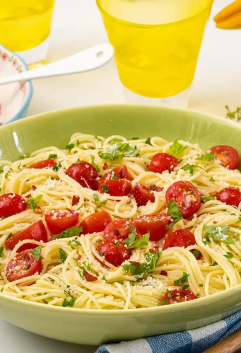 pioneer woman angel hair pasta tossed with browned butter, garlic and fresh herbs on a plate