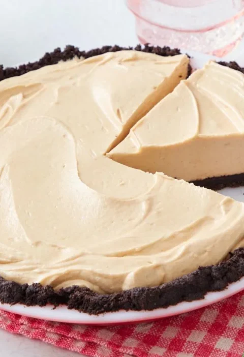 pioneer woman another pie chocolate peanut butter pie sliced on a plate with an oreo cookie crust