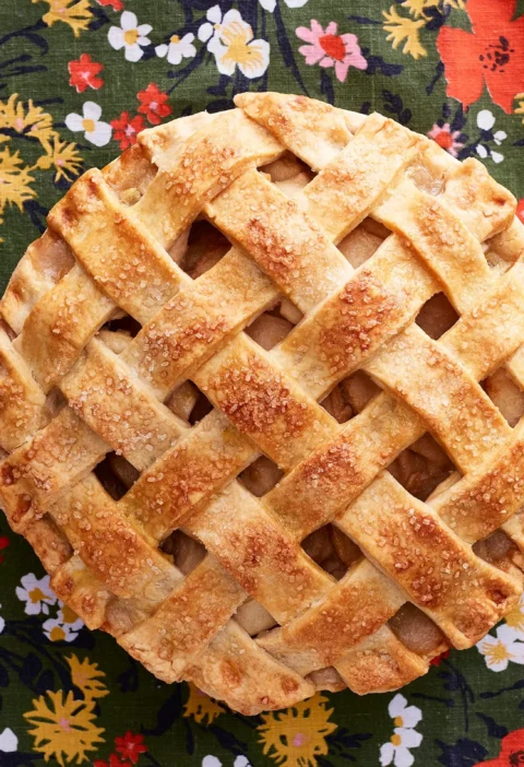 A golden lattice-topped pioneer woman apple pear lattice pie with fruit filling visible through the woven crust