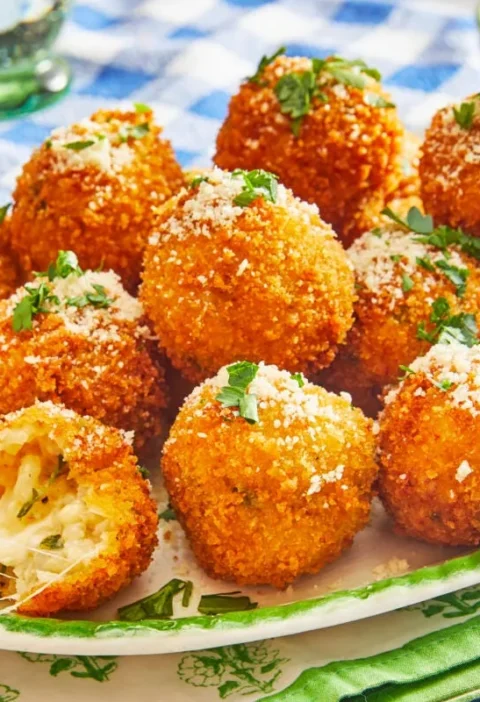 Golden crispy pioneer woman arancini served on a plate, showing the crispy panko coating and creamy risotto filling