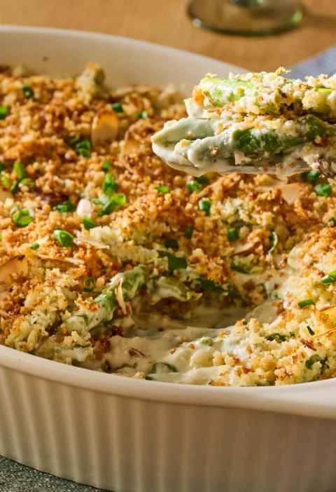 Pioneer Woman asparagus casserole in a baking dish with golden panko almond topping over cheesy asparagus spears