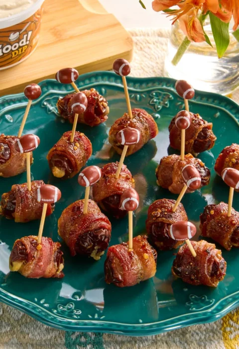Bacon-wrapped Medjool dates with horseradish dip filling arranged on a wire rack, glazed with honey and red pepper flakes for Pioneer Woman bacon horseradish dates