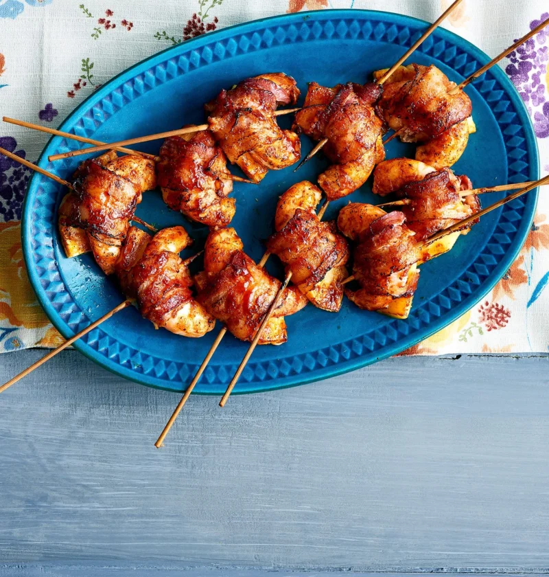 Bacon shrimp skewers on a wire rack glazed with barbecue sauce