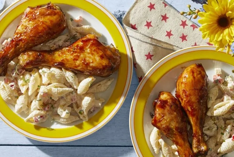 Barbecue chicken drumsticks glazed with a sticky chipotle-molasses sauce on a baking sheet