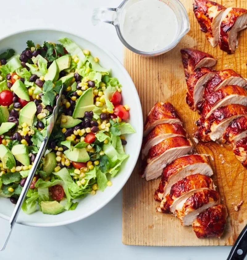 Pioneer woman barbecue chicken salad with BBQ-glazed chicken on romaine lettuce with corn, black beans, avocado and ranch dressing