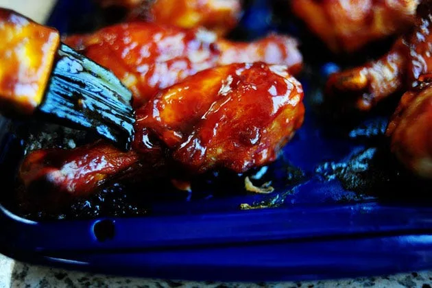 Pioneer woman barbecue chicken legs coated in smoky chipotle adobo sauce on a broiler pan