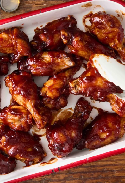 Crispy BBQ chicken wings glazed with smoky chipotle barbecue sauce on a plate